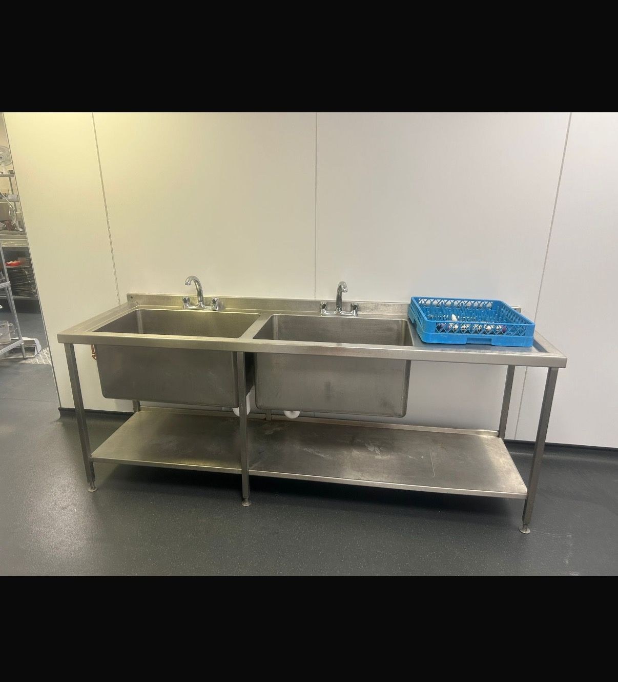 Twin-basin stainless-steel commercial sink station reinstalled by AJL after new pipework fitted